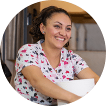 A housekeeper smiling at work.